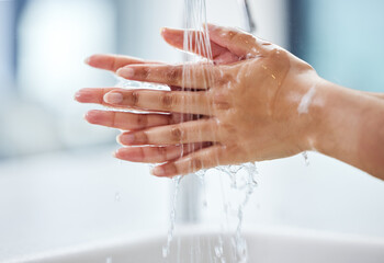 Woman, water and hands for hygiene, healthcare and germ protection in bathroom. Skincare, liquid...