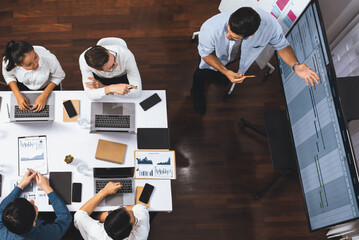 Top view analyst team utilizing BI Fintech to analyze financial data at table in meeting room....