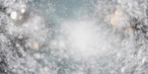 A wintry Christmas scene: large and small snowflakes gently descend upon the white landscape against a pale blue sky. Blurred bokeh effect, swirling motion.
