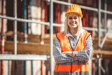 Architect woman happy on construction site in industry, planning and inspectioning. Wearing helmet...