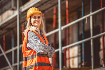 Architect woman happy on construction site in industry, planning and inspectioning. Wearing helmet...