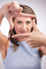 Woman, studio and frame hands with fingers, photography and profile picture or perspective with hand gesture. Focus, camera sign and portrait or looking, happy and confident face on background