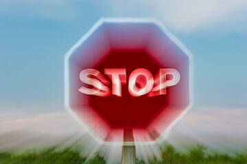 Stop traffic sign, obtained with the zooming effect, rapid movement of the lens zoom. Close-up.