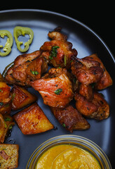 Juicy pieces of fried pork with onions and herbs. Close-up