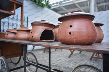 A collection of clay ceramic cooking stoves as decoration in front of a local restaurant