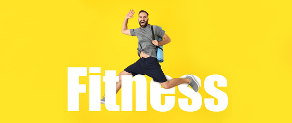 Young sporty man jumping against color background