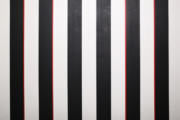 Fototapeta premium Alternating black and white stripes with a single red stripe breaking the pattern