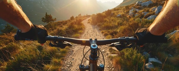 A view of the rider on the bicycle in the beutiful moutain path vwith sunset and nice landscape views.