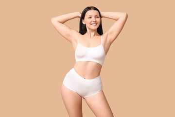 Obraz premium Body positive woman in underwear on beige background