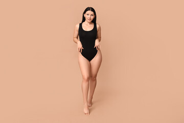 Body positive woman on beige background