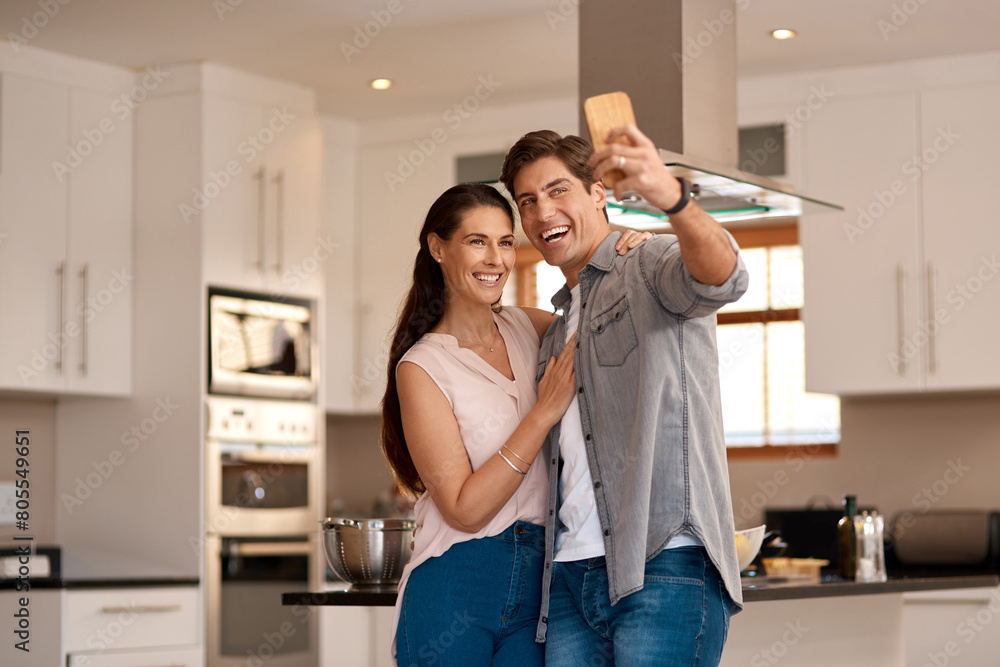 Poster Couple hug, kitchen and selfie with smile for profile picture together, social media post and digital gallery. Home, woman and man for photo on mobile with embrace for happy memory, relax and love