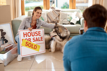 House sold, woman and unpacking in living room with pet, happiness and man taking picture. New...