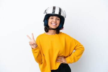 Woman with a motorcycle helmet smiling and showing victory sign