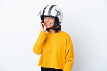 Woman with a motorcycle helmet keeping a conversation with the mobile phone