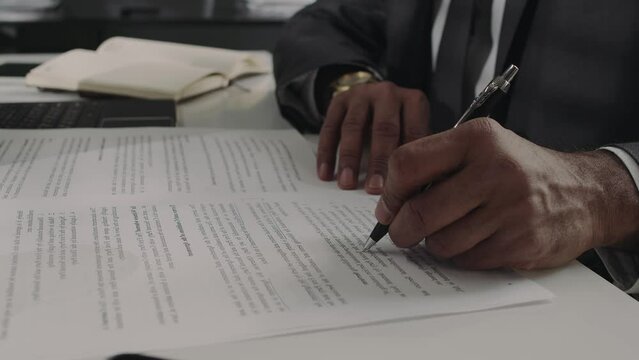 Anonymous Solicitor Making Notes In Contract In Office
