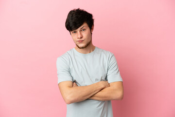 Young Russian man isolated on pink background with unhappy expression
