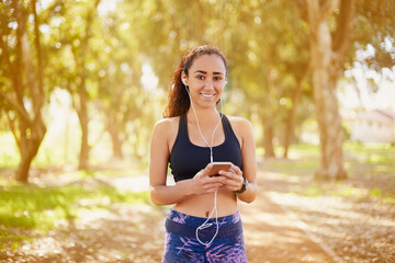 Black woman, earphones and portrait in park for exercise, sport training and podcast for run....