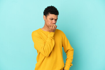 Young African American man isolated on blue background having doubts