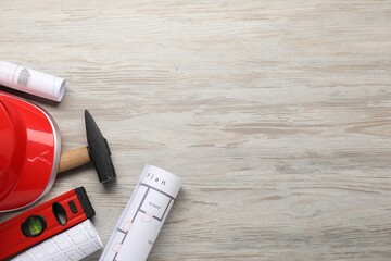Flat lay composition with building level and other construction tools on white wooden table, space...