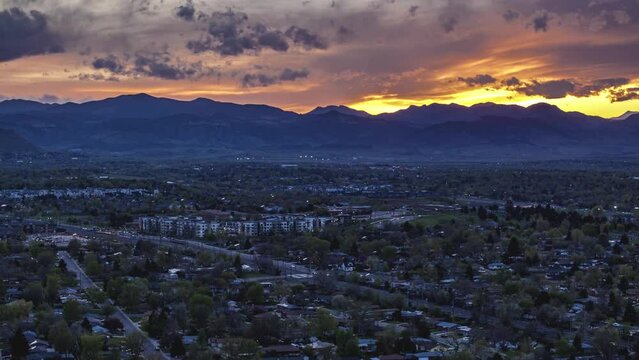 Sunset over the mountains and city suburbs, drone hyperlapse, Arvada, Colorado