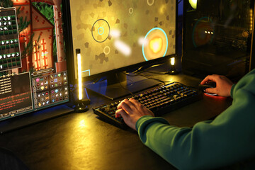 Man playing video games on computer indoors, closeup