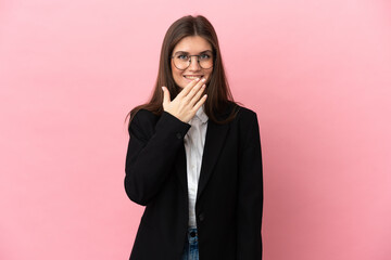 Young Business caucasian woman isolated on pink background happy and smiling covering mouth with hand