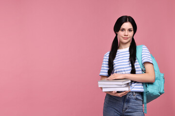 Student with books and backpack on pink background. Space for text