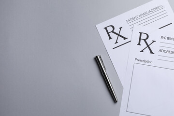 Medical prescription forms and pen on light grey background, flat lay. Space for text