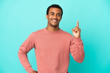African American handsome man on isolated blue background showing and lifting a finger in sign of...