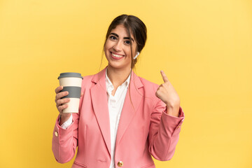 Business caucasian woman isolated on yellow background giving a thumbs up gesture