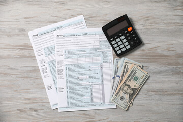 Payroll. Tax return forms, calculator and dollar banknotes on wooden table, flat lay