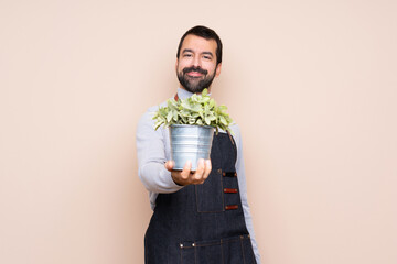 Man holding a plant over isolated background