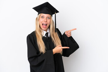 Young university graduate caucasian woman isolated on white background surprised and pointing side
