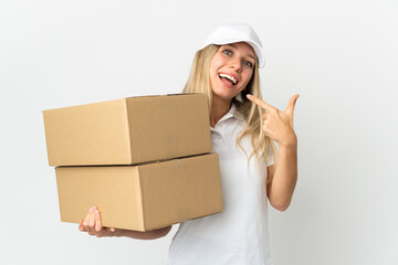 ¬°Young delivery woman isolated on white background giving a thumbs up gesture