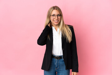 Business blonde woman isolated on pink background laughing