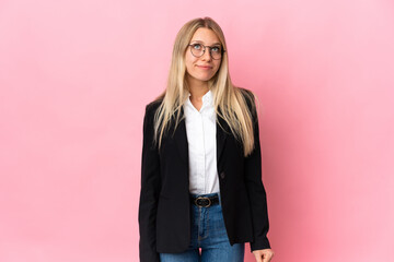 Business blonde woman isolated on pink background and looking up