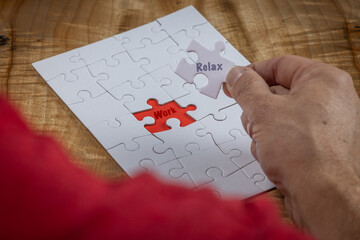 Blank puzzle with the missing piece being held next to the whole with a red placer where the last...