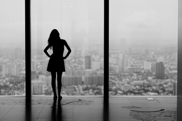silhouette of a woman and looking the city in a skyline during holidays