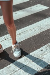 Person standing on crosswalk with shoes. Suitable for urban lifestyle concepts