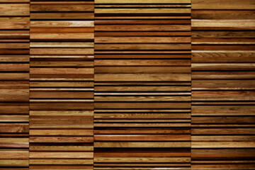 A close-up photo for background material of a wall made of many layers of long thin boards