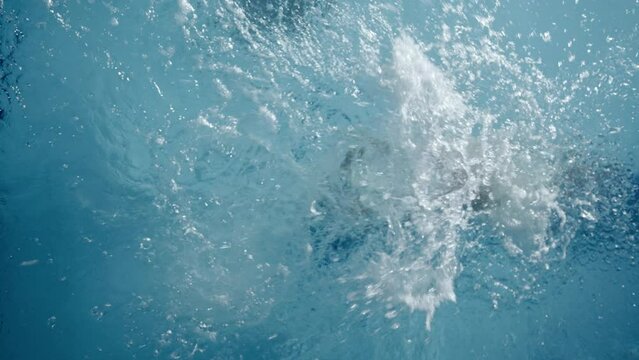 Woman pushing off the wall in a swimming pool