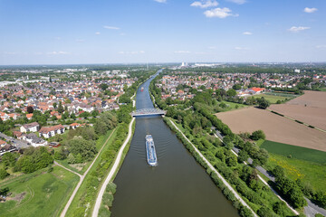 an aerial view of a boat traveling down a Mittellandkanal river 5K drone view Hanover Germany 