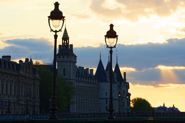 Dramatic sunset over river Seine and Conciergerie in Paris, France. Colourful travel background.