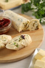 Tasty bread with butter, green onion, chili peppers and olives on wooden table