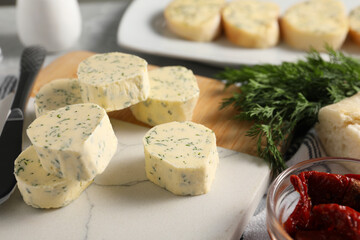 Tasty butter, dill and chili pepper on table, closeup