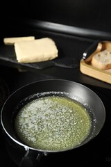 Melting butter in frying pan on table