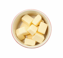 Tasty butter cubes in bowl isolated on white, top view