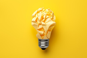 Crumpled yellow piece of paper inside a lightbulb - Powered by Adobe