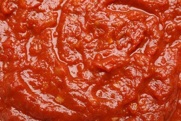 Homemade tomato sauce as background, top view