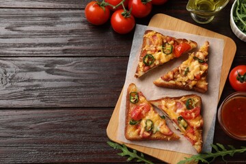 Tasty pizza toasts and ingredients on wooden table, flat lay. Space for text